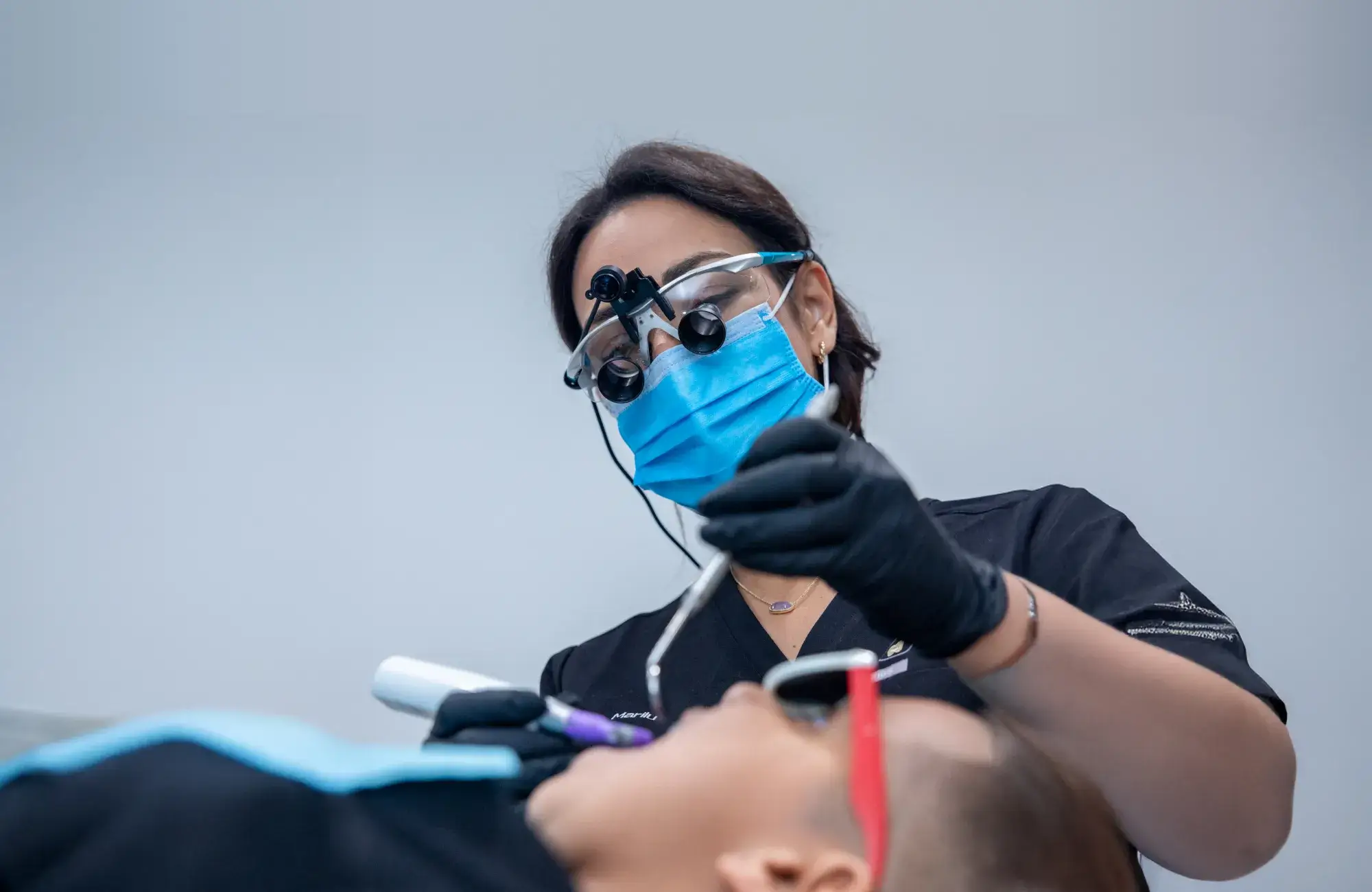 Dentist performing a tooth extraction procedure at Charming Smiles of Ocoee