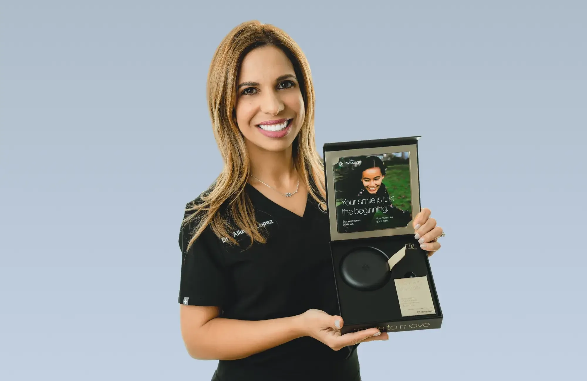 Patient holding clear Invisalign aligners at Charming Smiles of Ocoee