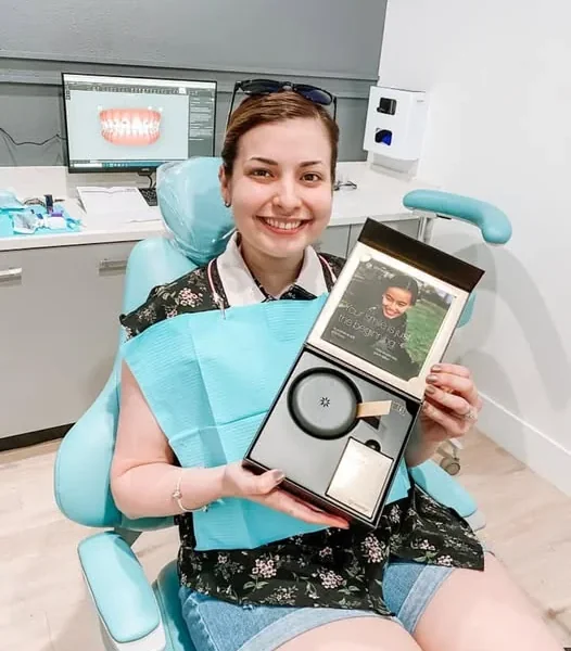 Patient smiling with clear Invisalign aligners